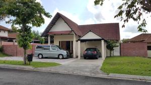a house with two cars parked in the driveway at Lot 1281, Villa D'Amour in Melaka