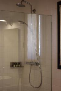 a shower with a shower head in a bathroom at Hotel Fundació L'Olivar in Ventalló +70 photos