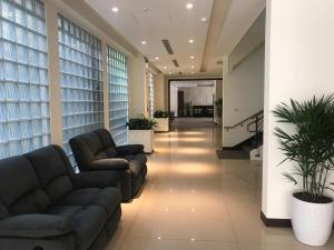 a lobby with couches and plants in a building at 晨光飯店 in Chiayi City