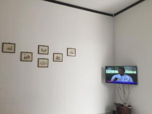 a tv on a wall in a room with pictures at Lot 1281, Villa D'Amour in Melaka