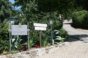 a garden with signs and flowers on a street at Agriturismo Podere La Fornace in Cavriglia