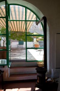 a room with a large window and a patio at La Locanda del Barbablù in Stromboli