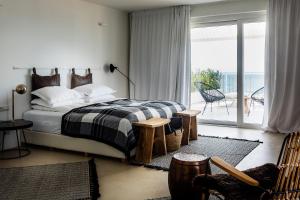 a bedroom with a bed and a balcony at Sea Sense Boutique Villa & Relax Zone in Sozopol +49 photos