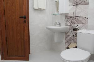 a bathroom with a toilet and a sink at Villa Salena in Primorsko +68 photos