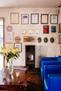 a living room with a vase of flowers on a table at Ice House Hotel in Ballina