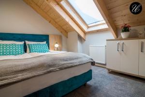 a bedroom with a large bed with a skylight at U przyjaciol - Debki in Dębki