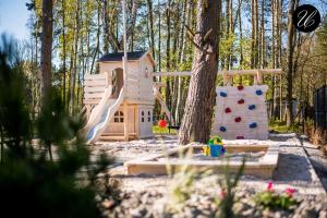 a playground with a play house and a slide at U przyjaciol - Debki in Dębki