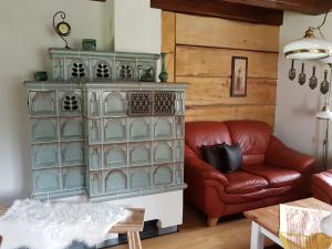 a living room with a red couch and a dresser at Ferienwohnung Zum Heuschober in Burg