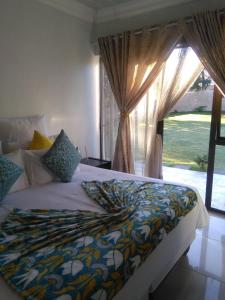a bedroom with a large bed with a window at Dudsk Bed & Breakfast in Newcastle