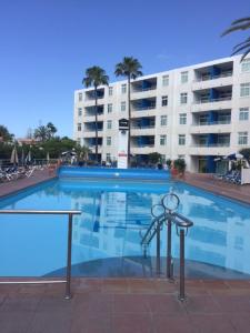 a large swimming pool in front of a building at Apartamentos Tamaragua in Playa del Ingles