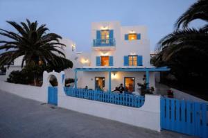 a large white building with a blue fence in front of it at Villa Sophie in Naousa +19 photos