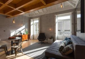 a living room with a couch and a table at Gold & Grey Loft Almada in Porto