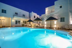 a swimming pool in front of a hotel at night at Villa Adriana Hotel in Agios Prokopios
