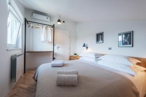 a bedroom with a large bed and a window at The Park Apartments in Zadar