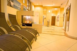 a waiting room with chairs and a fireplace at Badener Hof in Baden