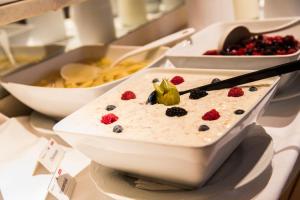 a bowl of rice pudding with berries on a table at Badener Hof in Baden