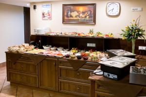 a buffet line with many different types of food at Hotel Maksymilian in Krakow