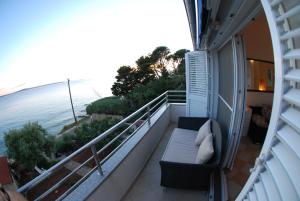 a balcony with two chairs and a view of the ocean at Blue Lagoon in Silba