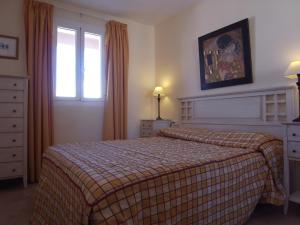 a hotel room with two beds and a window at Soling 103 in La Manga del Mar Menor