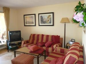 a living room with a couch and a tv at Soling 103 in La Manga del Mar Menor