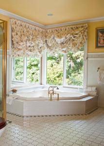 a large bathroom with a large tub in front of a window at Burnbank in Berwick