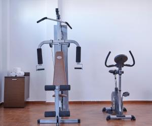 two exercise bikes sitting next to each other in a room at Terra Blue Santorini in Kamari
