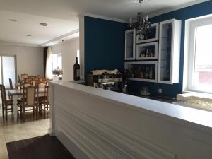 a bar in a dining room with a blue wall at Hotel International in Međugorje