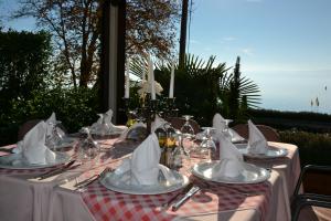 a table with plates and napkins on top of it at Hotel Dva Bisera in Ohrid