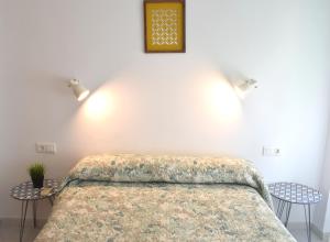 a bedroom with a large bed with two tables at El Jardin BeNerja in Nerja