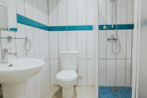 a white toilet sitting next to a bath tub at Stephanie Studios in Larnaca