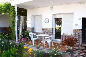 a patio with two chairs and a table on a house at El Jardin BeNerja in Nerja