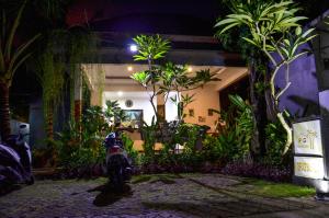 a fire hydrant in front of a building with plants at Palm Garden Bali in Nusa Dua