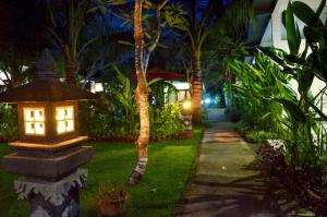 a garden at night with a lantern in the grass at Palm Garden Bali in Nusa Dua