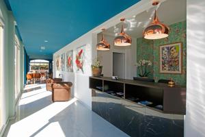a hallway of a house with blue ceilings at Hotel Onda in Calvi