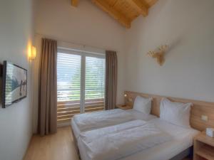 Łóżko lub łóżka w pokoju w obiekcie Residenz Kitzsteinhornblick by Kaprun Rentals