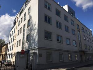 a large white building on the side of a street at Superior Apartment near the city center in Tartu