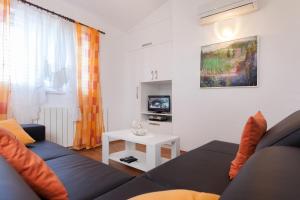 a living room with a couch and a table at Villa Noa in Makarska