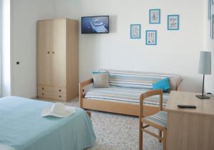 Un ou plusieurs lits dans un hébergement de l'établissement Appartamento La Vela
