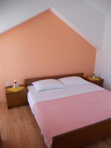 a bedroom with a large bed and two night stands at Apartments Violeta in Betina