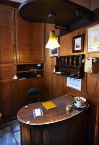 a kitchen with a wooden table and a lamp at Pensione Oliva in Lagonegro