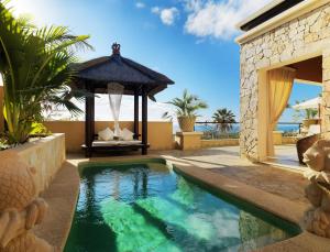 a swimming pool in a backyard with a gazebo at Royal Garden Villas, Luxury Hotel in Adeje