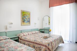 Postel nebo postele na pokoji v ubytování Hotel Villa Gori