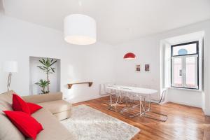 a white living room with a couch and a table at The Lisbon-Way Apartments in Lisbon