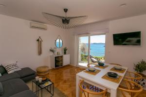 a living room with a couch and a table at Apartments Sea in Trogir
