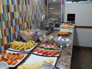 a buffet of fruits and vegetables in a kitchen at Frimas Hotel in Belo Horizonte
