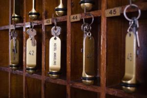 a row of measuring utensils hanging on a wall at Hotel Angelino in Ischia
