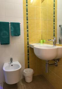 a bathroom with a sink and a toilet at Hotel Vienna in Senigallia +30 photos