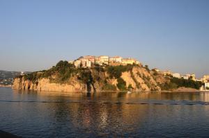 a small island in the water with houses on it at Antico Casale - Camere con angolo cottura in Agropoli