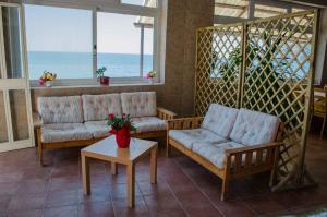 a living room with two couches and a table at Hotel Angelino in Ischia