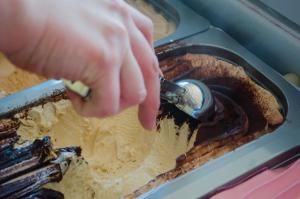 a person is reaching into a chocolate dessert at Hotel Angelino in Ischia